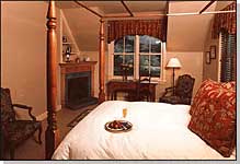 Second Floor. Overlooking the Gardens, a bright ivory and amber one-room suite furnished with an antique king-sized Sheraton four-poster, red and gold Anichini fabrics, gas fireplace and thermal massage tub for 2 in the sky-lighted bathroom